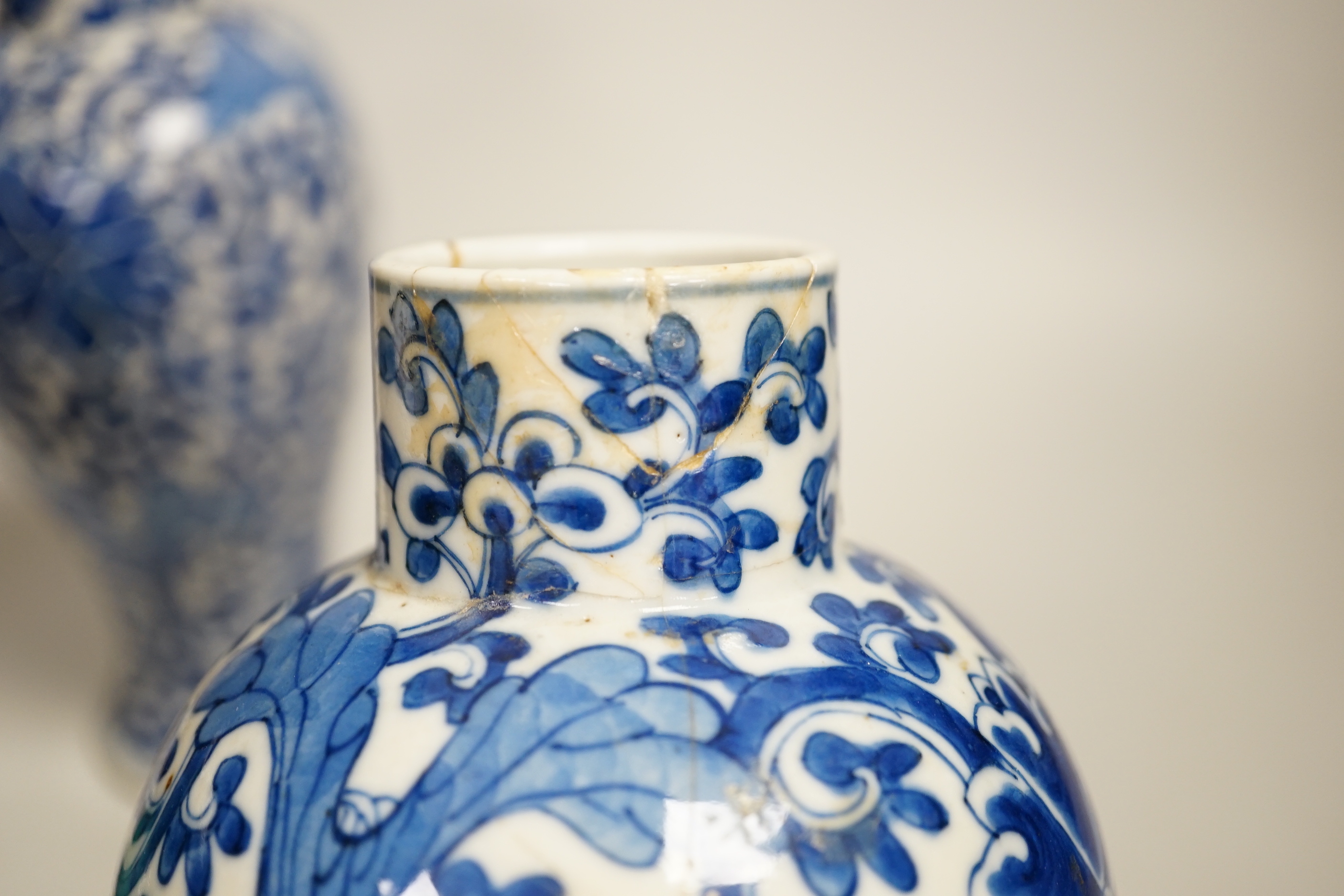 A pair of Chinese blue and white vases and a green glazed vase, blue vases 22.5cm high